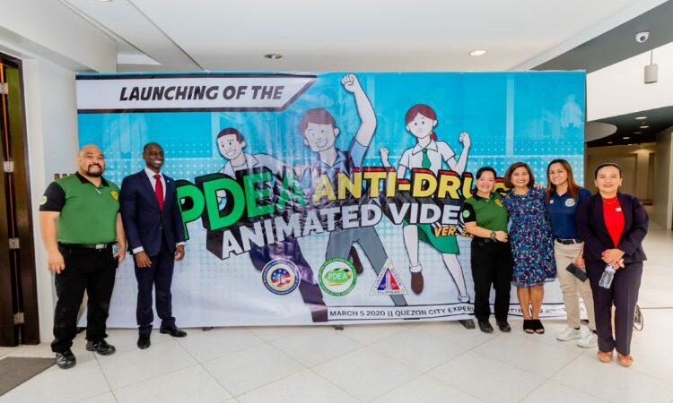 group in front of poster