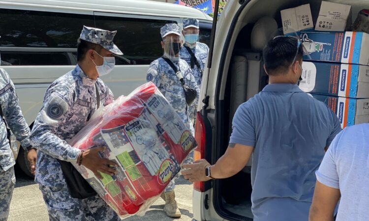 U.S. military personnel with Indo-Pacific Command’s Civil Military Support Element – Philippines and Philippine coastguardsmen work together to unload U. S. COVID-19 PPE donations.