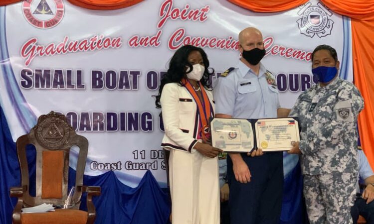 Lieutenant Mike Long of the United States Coast Guard (middle) alongside U.S. Embassy Manila’s International Narcotics and Law Enforcement Affairs Director Kelia Cummins (left) presents a token of appreciation to Philippine Coast Guard Commander Christie Cabuyaban (right) for support in conducting the event.