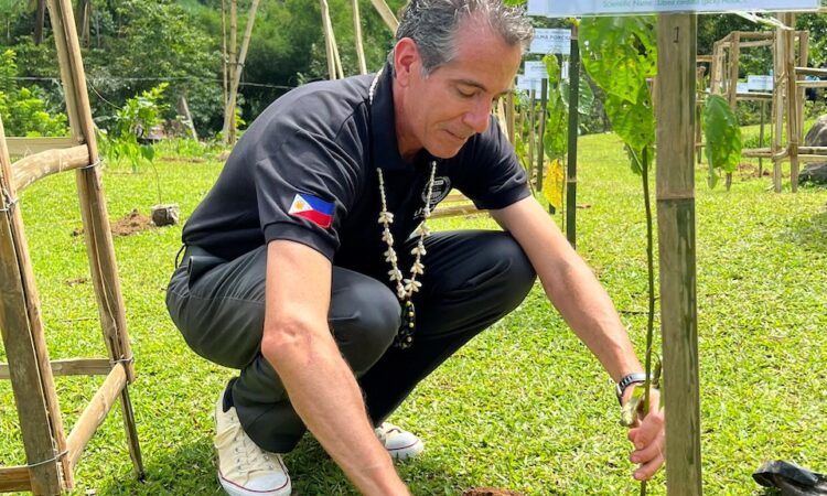 USAID Philippines Mission Director Ryan Washburn planting a tree