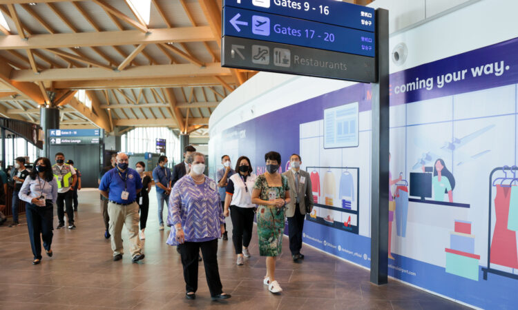 Chargé d'Affaires a.i. Heather Variava with a group of people inside the Clark Airport passenger terminal