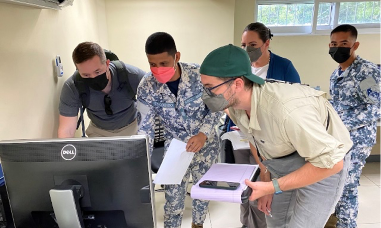 A Philippine Coast Guard member working at the NCWS demonstrates vessel traffic monitoring.