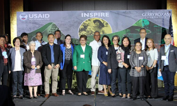 USAID Philippines Acting Deputy Mission Director Jennifer Crow (front, fifth from left), DENR Undersecretary Marilou Erni (front, sixth from left) and Gerry Roxas Foundation Executive Director Glen de Castro (rightmost) joins representatives of 13 grantees of USAID’s INSPIRE project at a ceremony on August 30.