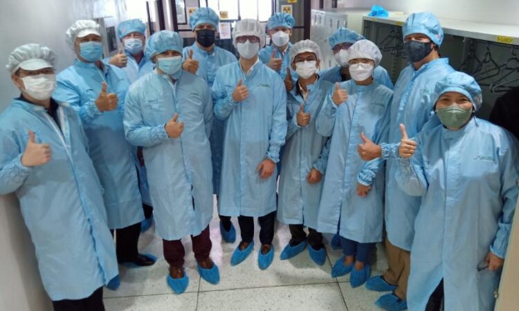 Group of people wearing lab gowns and caps