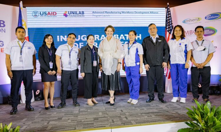 Ambassador Carlson onstage with AMdev trainees