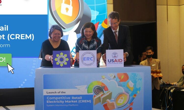 Three people on stage for the unveiling of the Competitive Retail Electricity Market (CREM) System Monitoring Platform