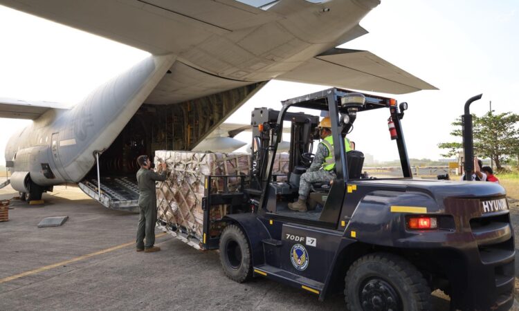 U.S. Marines and Philippine Air Force service members load Department of Social Welfare and Development family food packs into a C-130 provided by the United States government to support disaster response efforts in Mindanao on February 12.