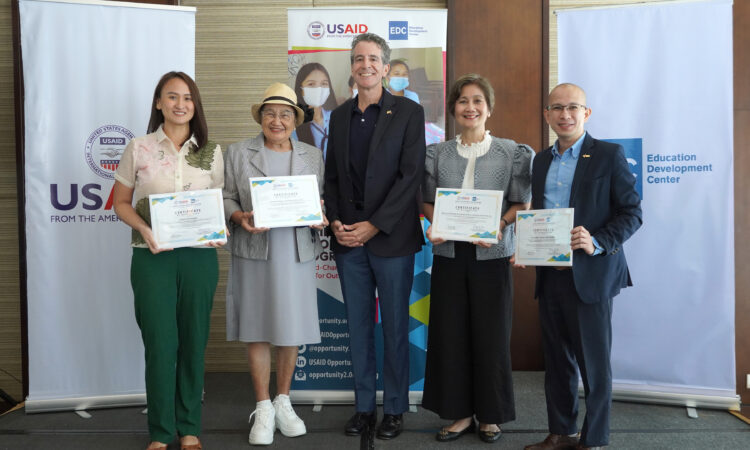 USAID Philippines Mission Director Ryan Washburn (center) hands over grant certificates to (from left) Quezon City Councilor Julienne Alyson Rae Medalla representing Quezon City University, Dr. Anicia A. Alvarez, President of Ferndale College Zamboanga Peninsula, Paulette Liu, President of School of Knowledge for Industrial Labor, Leadership and Service (SKILLS)., and Oscar Sherlo Reyes, Director of the De La Salle-College of Saint Benilde School of Deaf Education and Applied Studies.
