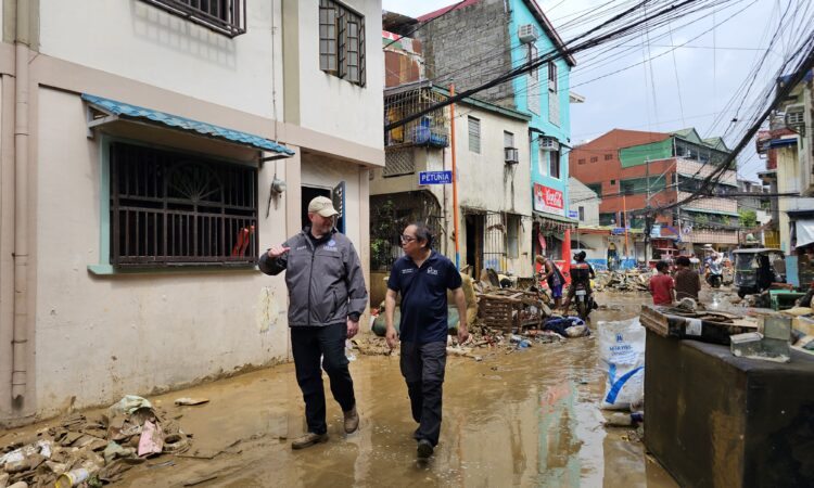 USAID Bureau of Humanitarian Assistance Regional Director for East Asia and the Pacific Ben Hemingway (left) and Catholic Relief Services Program Manager Arnaldo Arcadio (right) assess flooding damage across Metro Manila to ensure resources are deployed to areas and communities most in need.