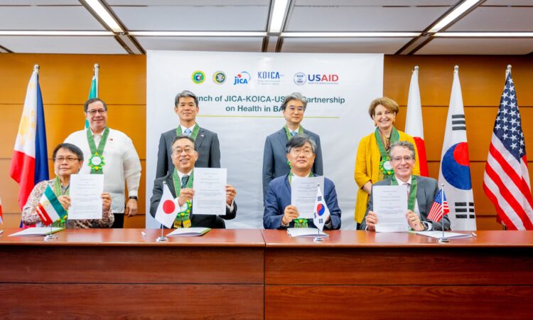(Standing from left) Philippine Department of Health Secretary Dr. Teodoro Herbosa, Japanese Ambassador Endo Kazuya, Korean Embassy Minister Sang Seung-Man, and U.S. Ambassador MaryKay Carlson witness the signing of a Memorandum of Cooperation between the Bangsamoro Autonomous Region in Muslim Mindanao’s Ministry of Health (BARMM-MOH) and the development agencies of Japan, South Korea, and the United States, represented by (seated from left) BARMM Minister of Health Dr. Kadil Sinolinding, Jr., Japan International Cooperation Agency (JICA) Chief Representative Sakamoto Takema, Korea International Cooperation Agency (KOICA) Country Director Kim Eunsub, and United States Agency for International Development (USAID) Philippines Mission Director Ryan Washburn.