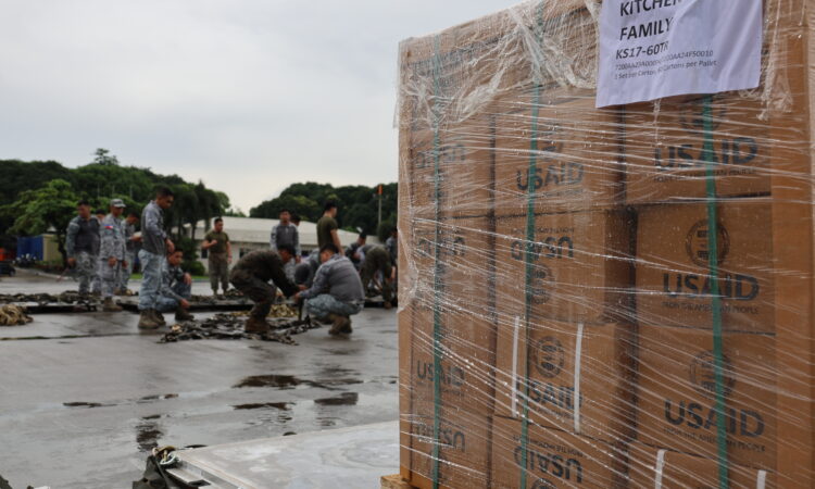 Military personnel unload U.S. government-donated emergency supplies in Batanes on October 8.