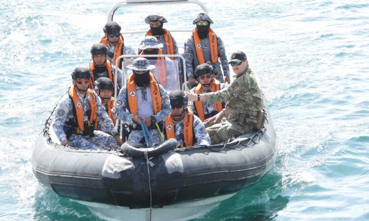 A student boarding team prepares to approach a larger vessel for a practice boarding in the Davao Gulf.