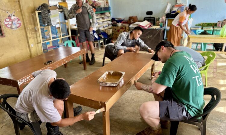 U.S. and Philippine service members paint tables at an elementary school in Rizal, Palawan, on June 10 as part of Brigada Eskwela, a nationwide effort to prepare schools for the new academic year.