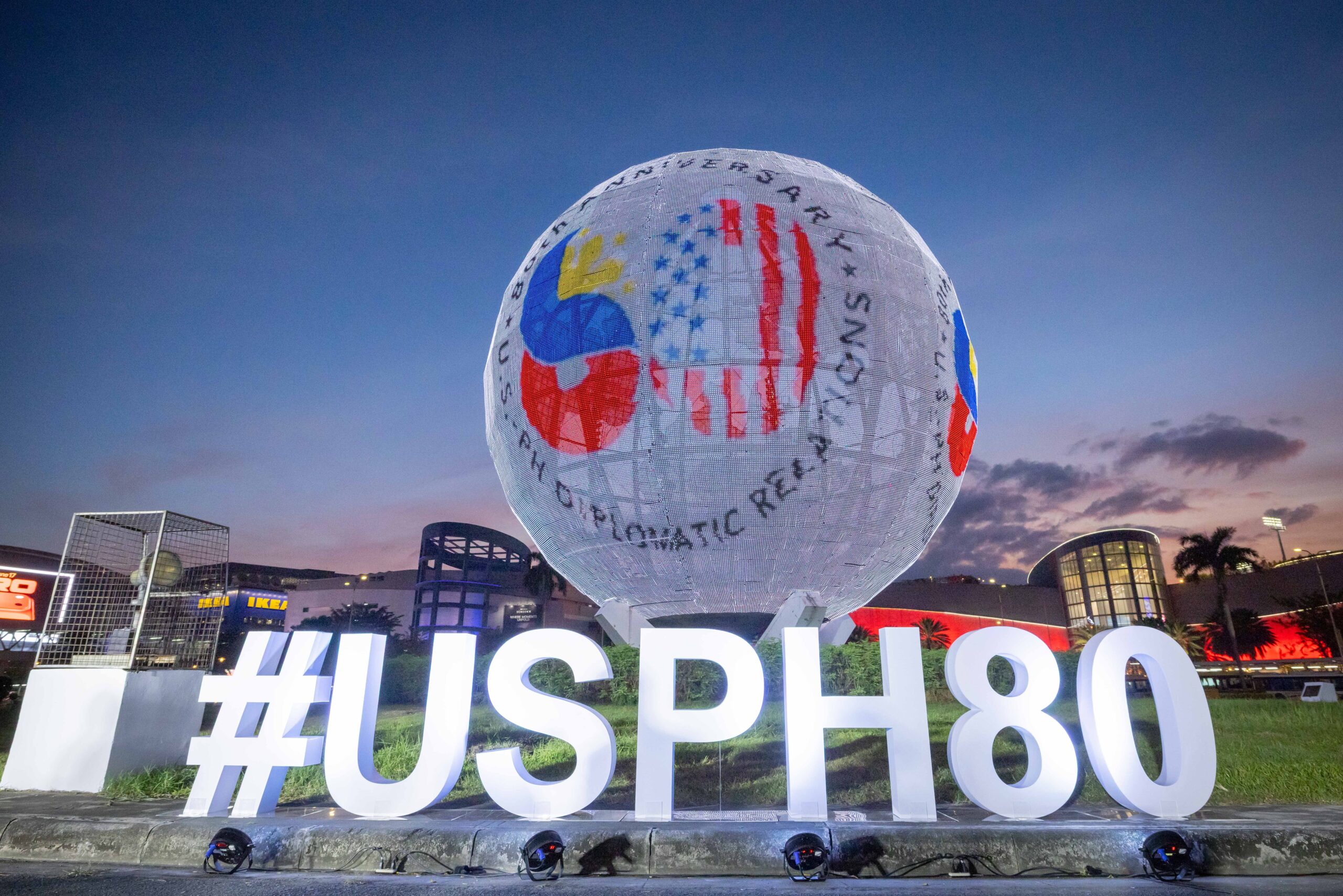The U.S.-Philippines 80th anniversary logo illuminates the SM Mall of Asia Globe in Pasay City.
